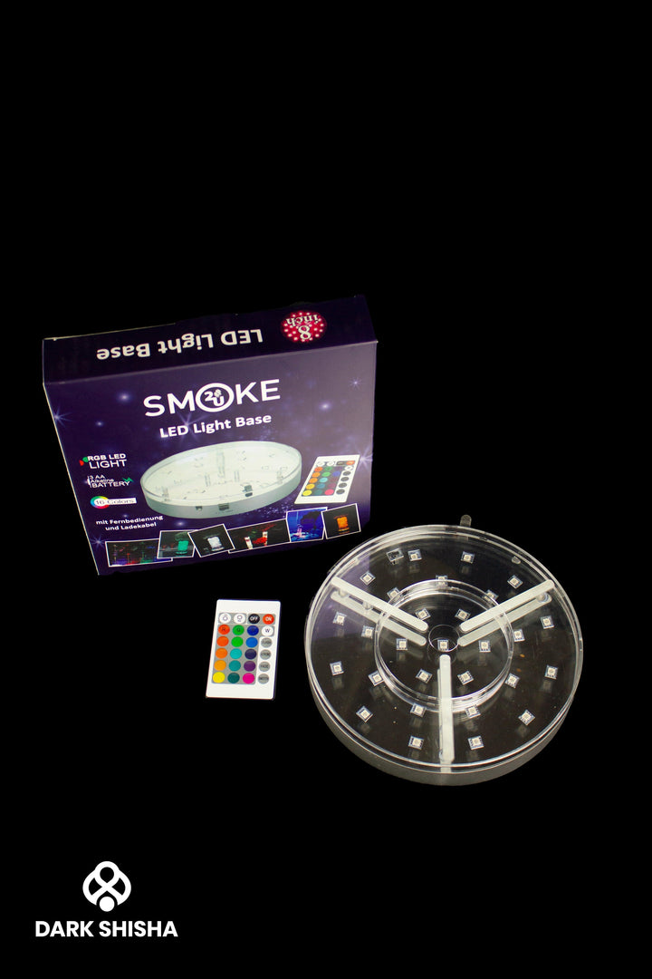 Base Luminosa LED Smoke2u per narghilè, con telecomando per selezionare vari colori e modalità di luce. Diametro 20 cm, funziona a batterie, ideale per creare un’atmosfera speciale durante le sessioni di fumo.